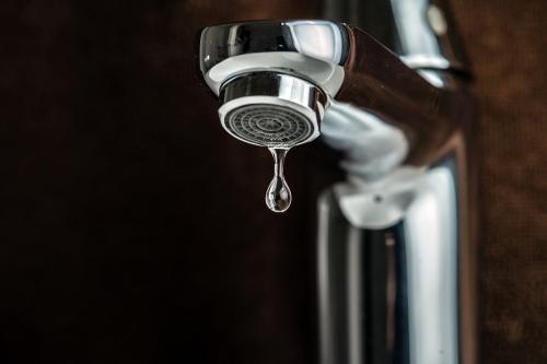 A Drop of Water Dripping From A Faucet