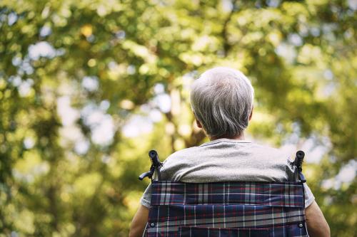 Rear view of a senior sitting in a wheelchair